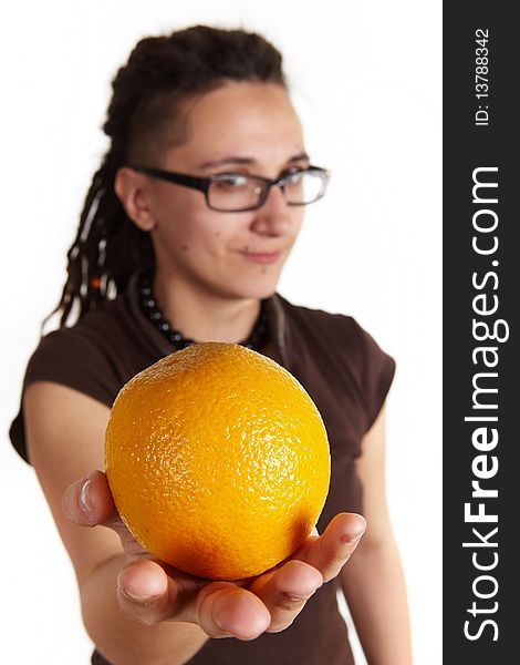 Girl with dreadlocks give an orange, isolated. Girl with dreadlocks give an orange, isolated