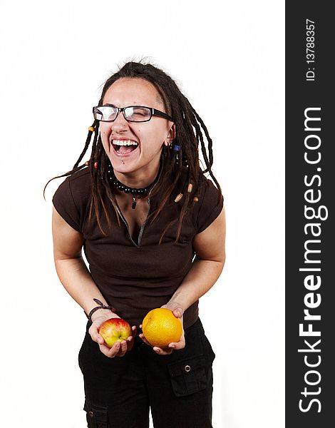 Girl with dreadlocks laught with apple and orange. Girl with dreadlocks laught with apple and orange