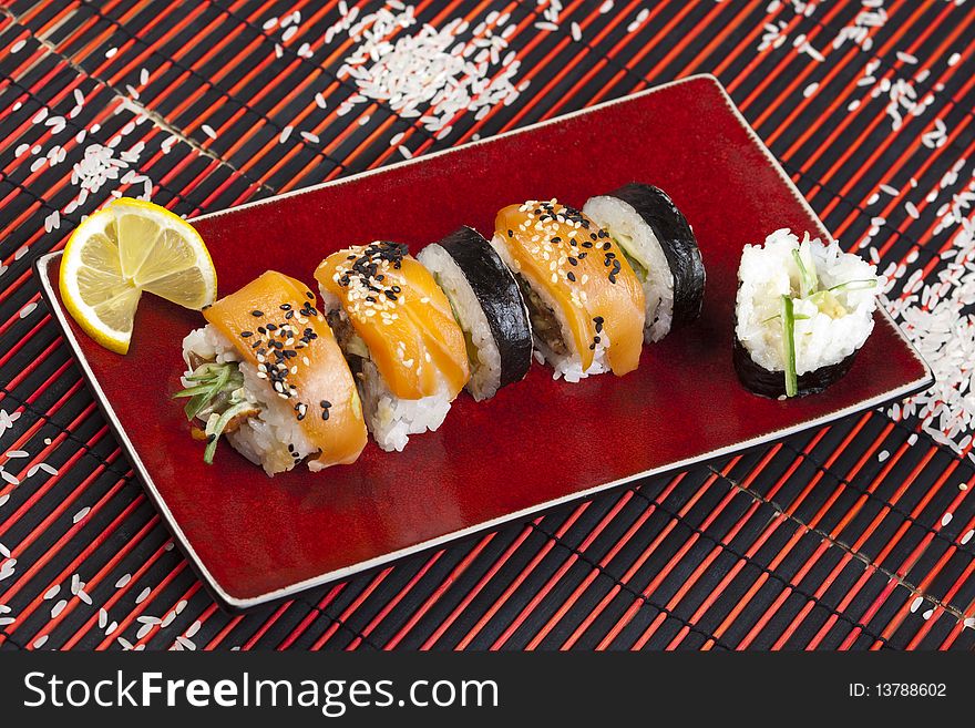 A complete sushi meal with chopsticks on tatami mat