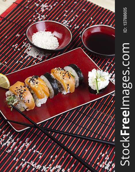 A complete sushi meal with chopsticks on tatami mat
