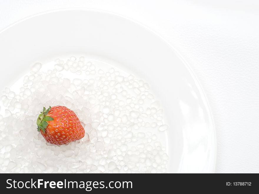 Strawberry and Glass Sand on the plate. Strawberry and Glass Sand on the plate