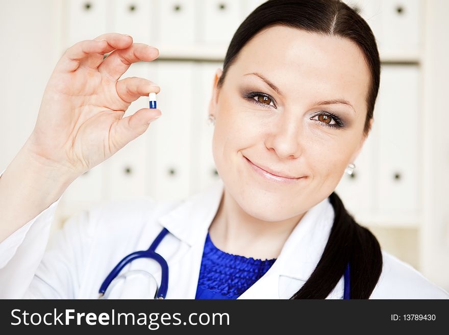 Doctor woman holding pill
