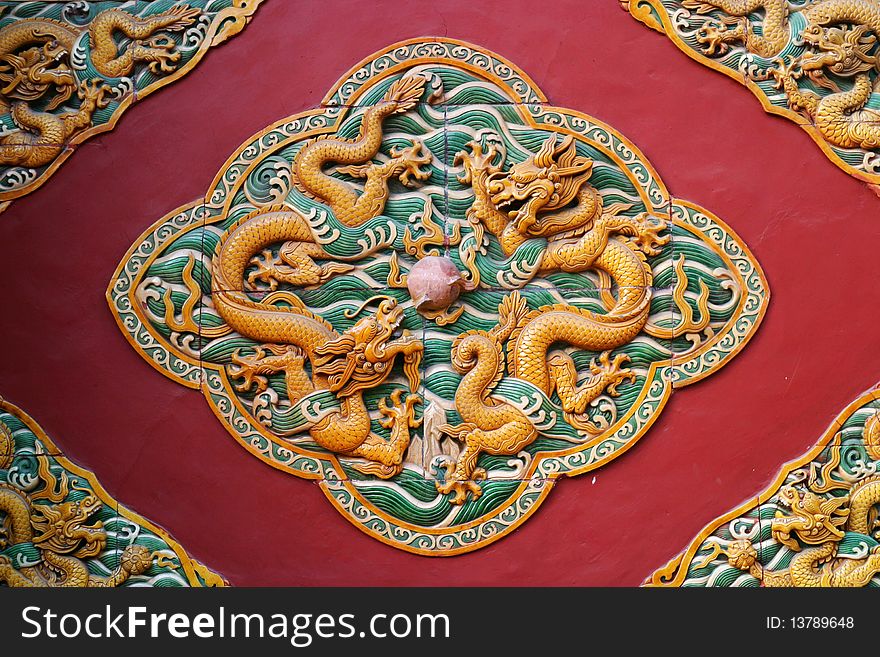 Dragon patterns of glazed tile sculpture on the wall of a chinese imperial temple