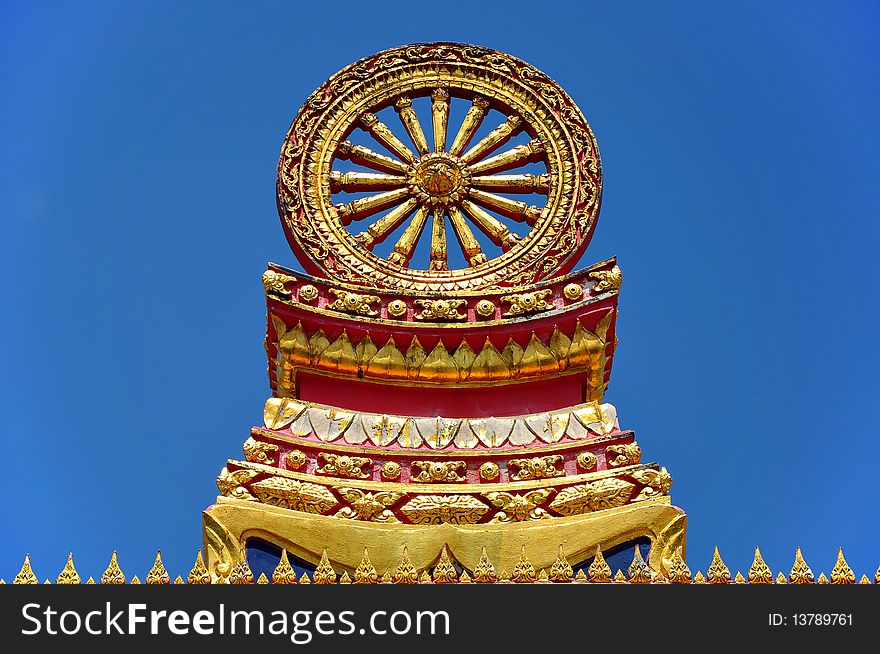 Wheel of Dhamma with blue sky.