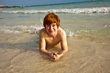 Happy Boy In The Foam At The Beach Stock Photography