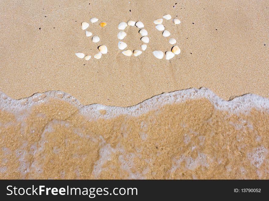 SOS in sand on a beach