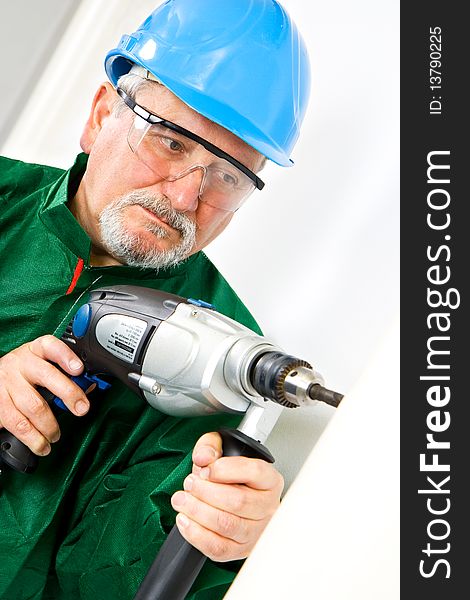 Construction worker holding the electric hand drill. Construction worker holding the electric hand drill