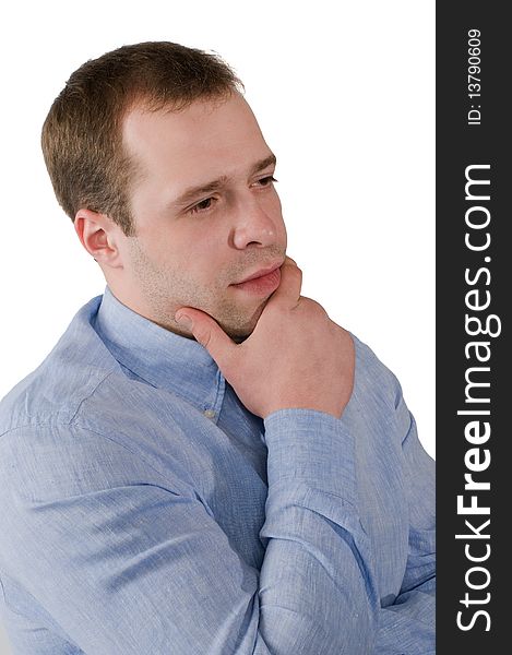 The man in a blue shirt thoughtfully rubs a chin, is isolated on a white background