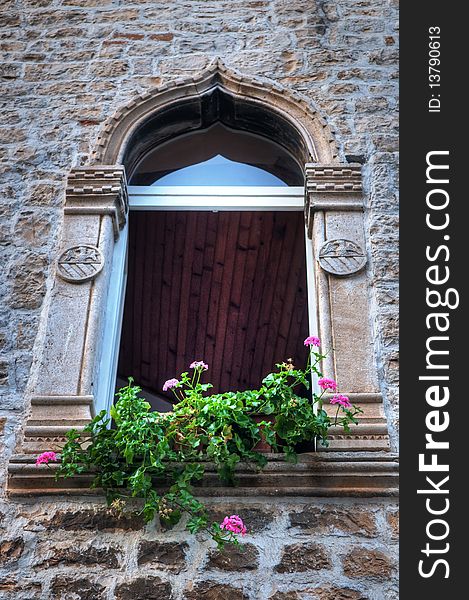 Window with an arch in the old stone house. Window with an arch in the old stone house