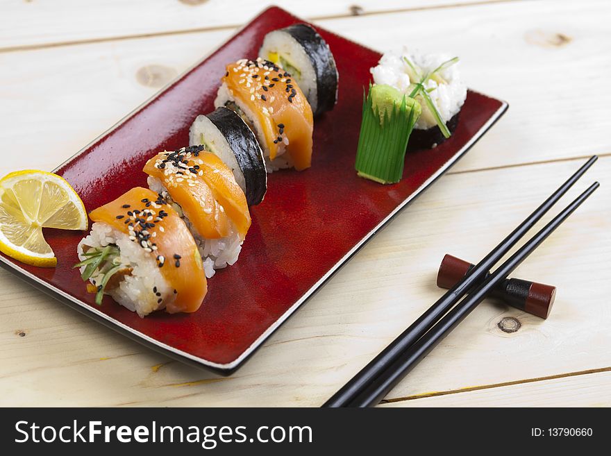 A complete sushi meal with chopsticks on wood. A complete sushi meal with chopsticks on wood