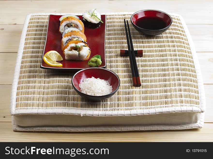 A complete sushi meal with chopsticks on tatami mat