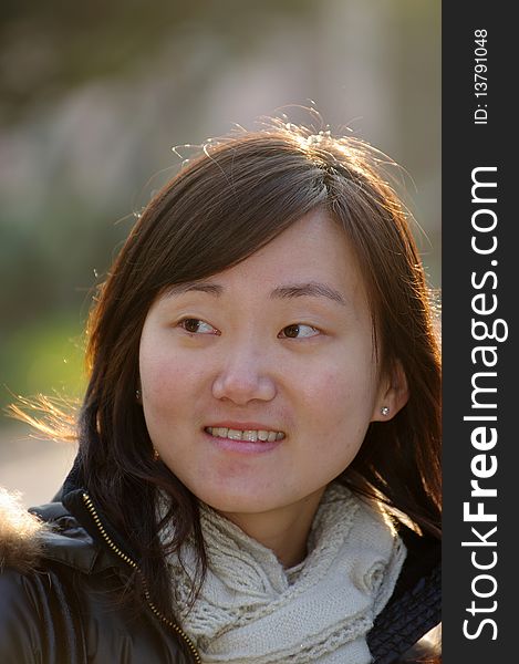 Smiling Chinese girl in Winter with white muffle.