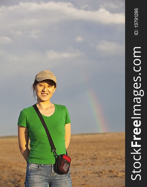 A young asian lady in the desert with rainbow. A young asian lady in the desert with rainbow