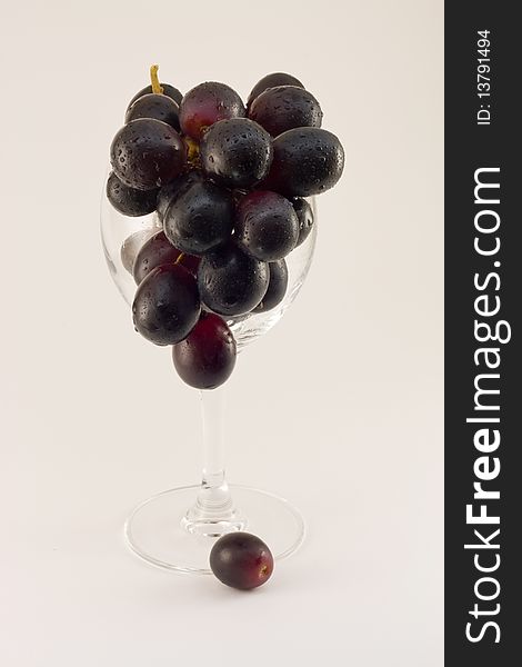 Grapes Cluster In Water Drops In A Glass