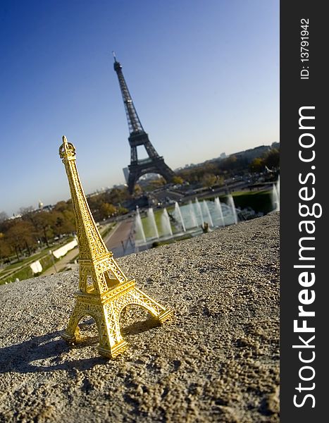 Eiffel tower miniature in front of real eiffel tower - Paris. Eiffel tower miniature in front of real eiffel tower - Paris