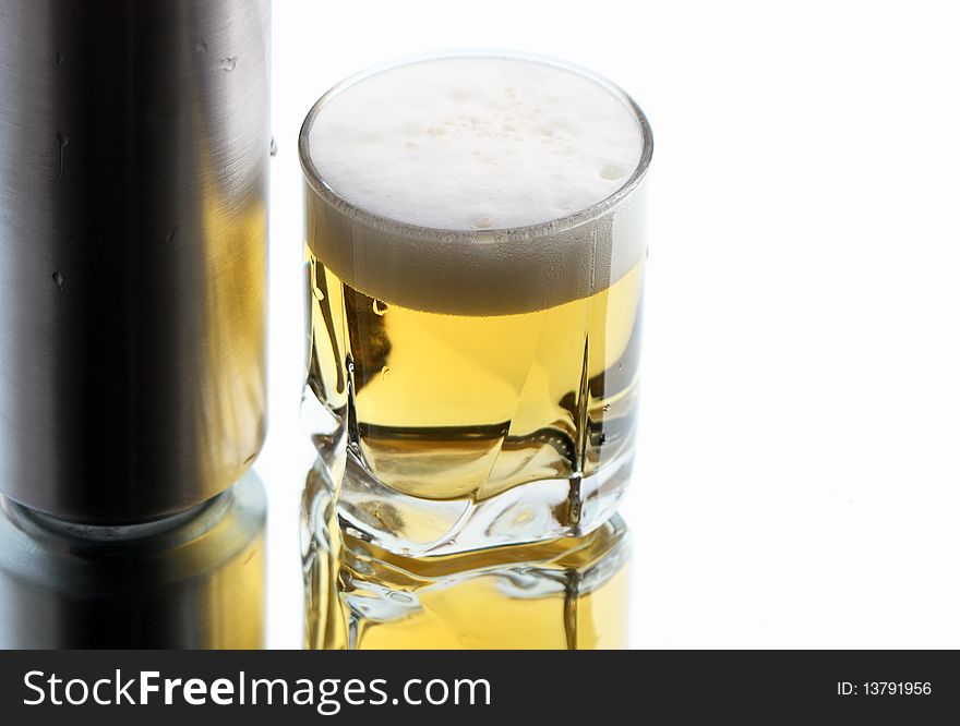 Closeup of beer glass and can on white background with reverberation. Closeup of beer glass and can on white background with reverberation