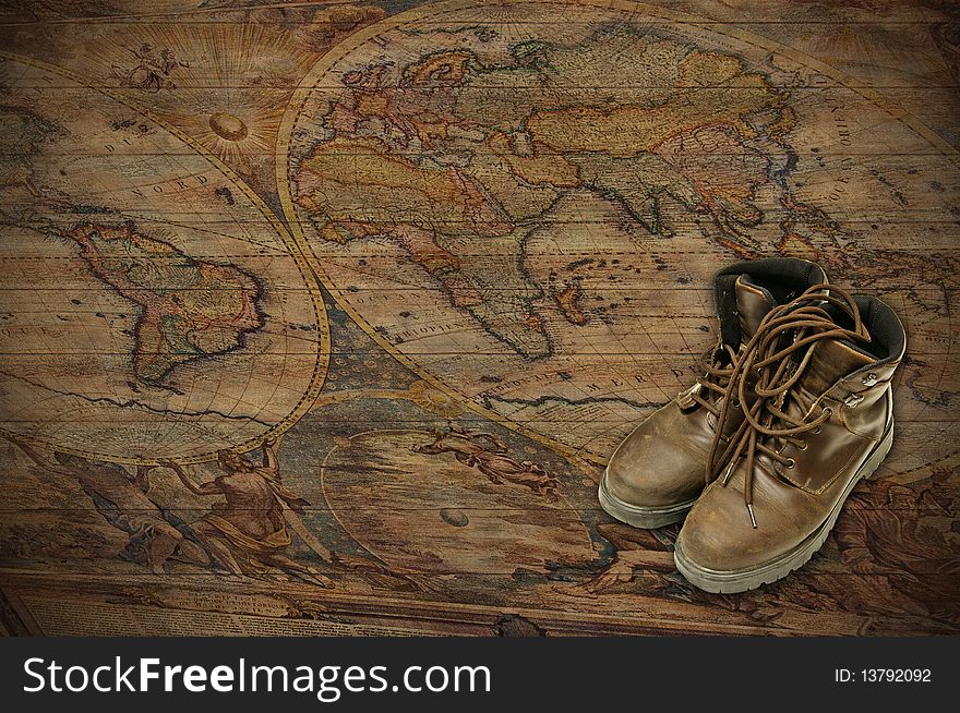 A world map on wood, with adventure boots. A world map on wood, with adventure boots