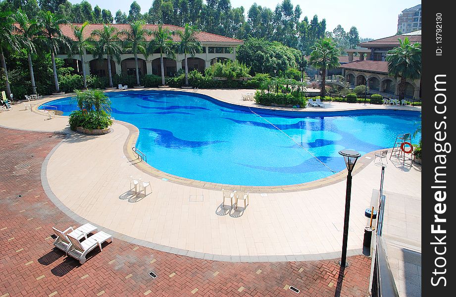 Sunny summer day large swimming pool in the hotel.