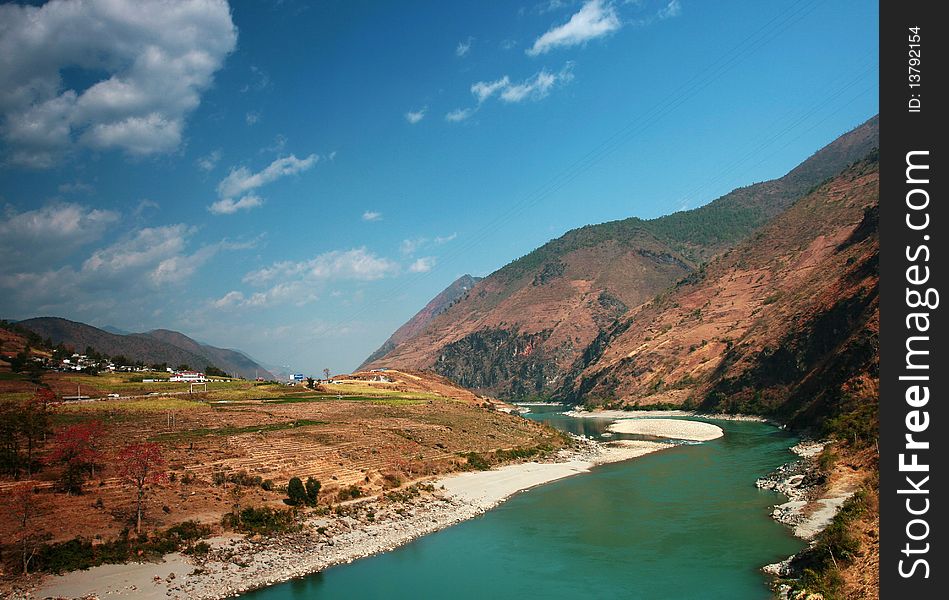 The Nu River Grand Canyon, in Yunnan, China. It's taken in Spring, the river is green and beautiful, surrounded by mountains are high, people living in the quiet of this beautiful land.