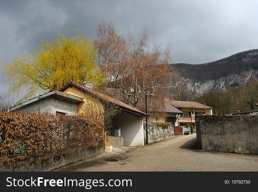 Small village street with view to the mountains Jura. Small village street with view to the mountains Jura