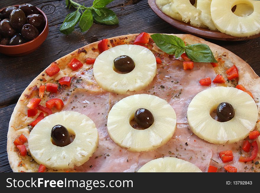 Pineapple pizza with olives and ingredients