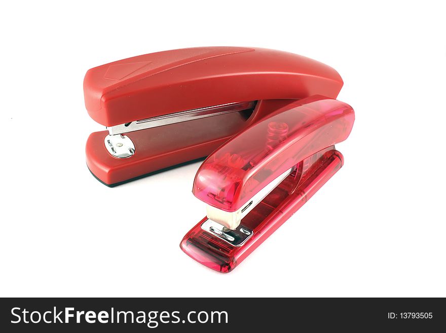 Two pink stapler on the white background.