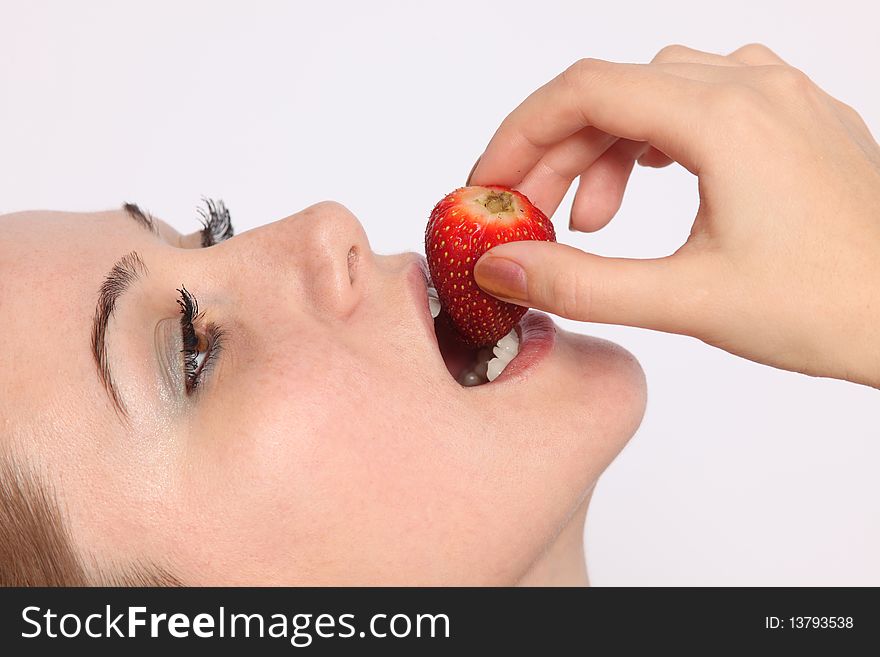 Close up of beautiful young woman eating strawberry. Close up of beautiful young woman eating strawberry