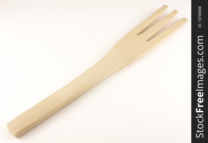 Wooden fork on the white background.