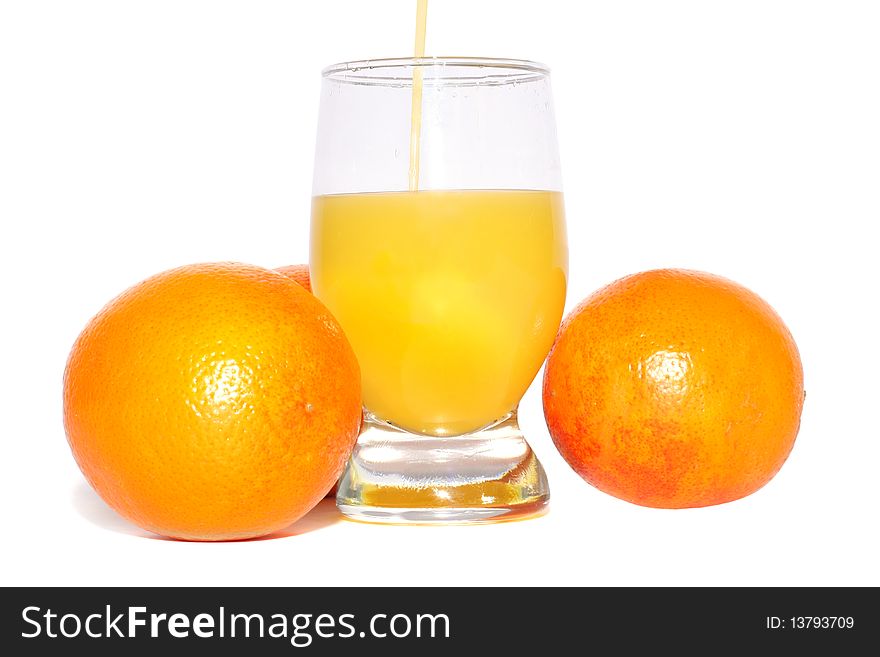 Oranges and glass of orange juice on a white background. Oranges and glass of orange juice on a white background