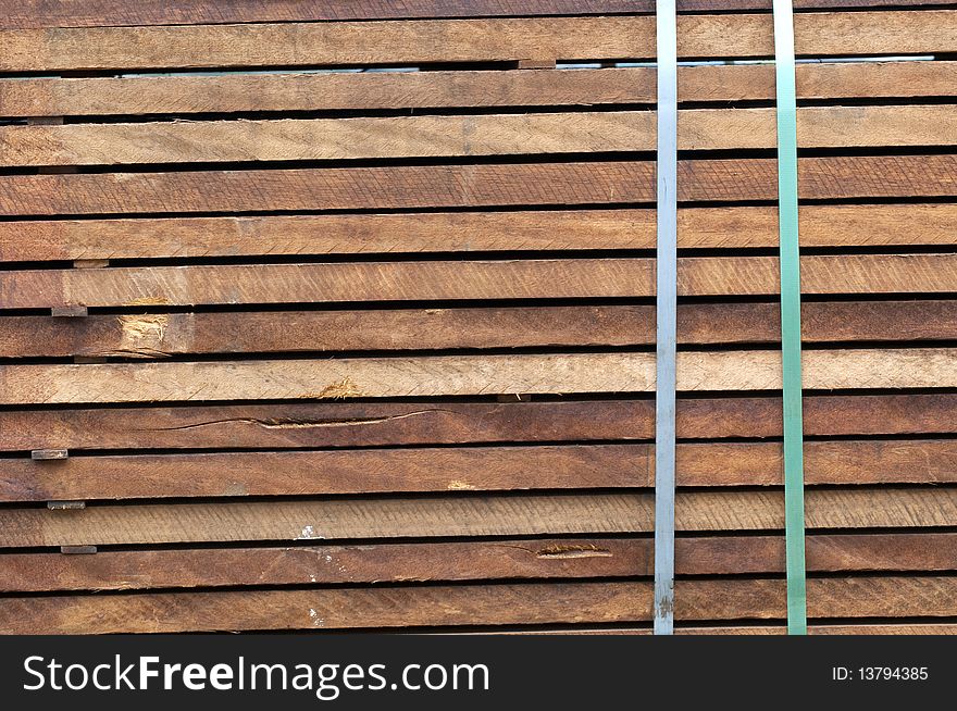 Piled up wood ready for transport at a sawmill. Piled up wood ready for transport at a sawmill