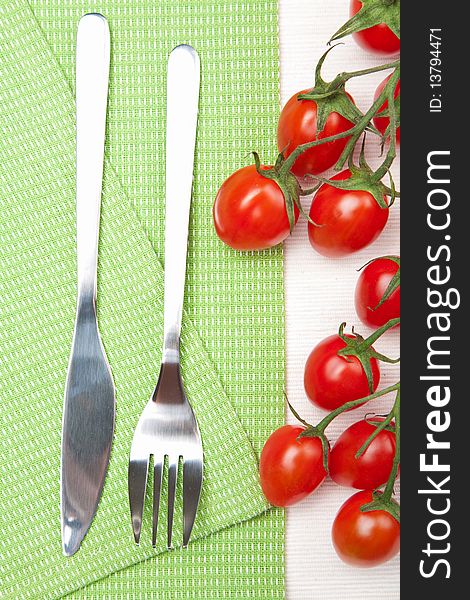 Closeup of fork knife and tomatoes