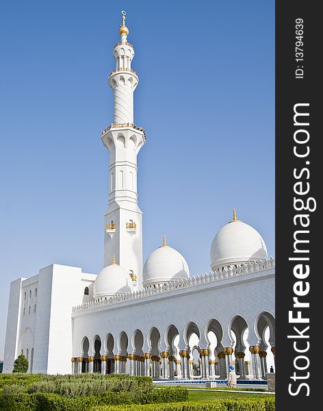 Exterior of a mosque with arches at the couryard and a minaret at the corner. Exterior of a mosque with arches at the couryard and a minaret at the corner