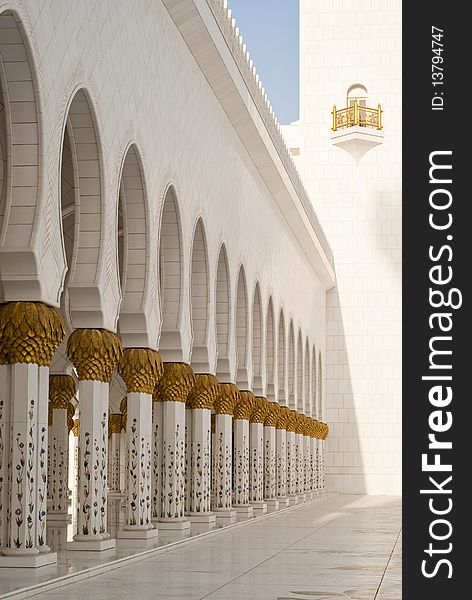 Arches at a mosque supported on fine intrecate columns with gold palm capitals