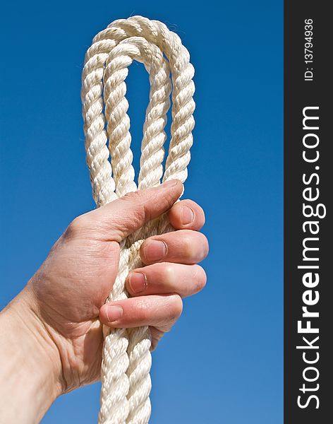 Cord in a hand on a blue background