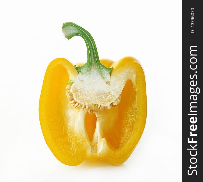 Yellow pepper cut into halves on a white background. Yellow pepper cut into halves on a white background