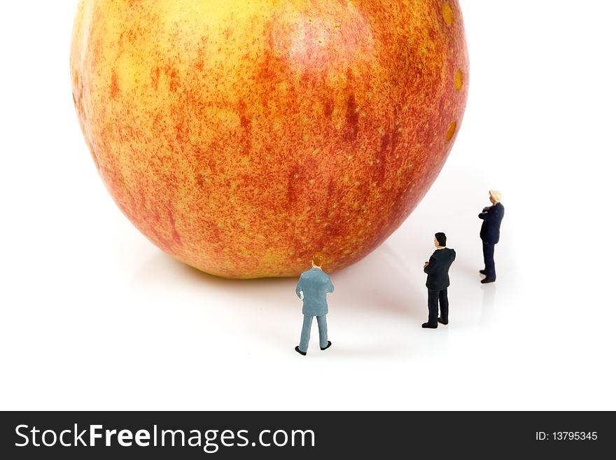 Business team with a apple isolated over a white background