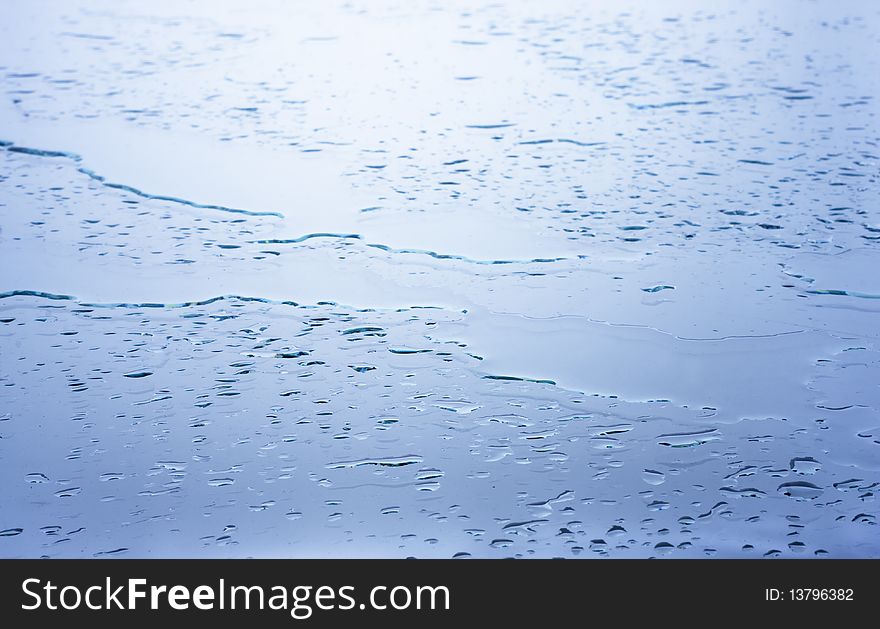 Wet glass surface covered with raindrops. Natural background.