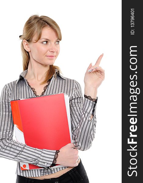 Young woman in business attire holding folder, showing on something by a finger - isolated on a white background. Young woman in business attire holding folder, showing on something by a finger - isolated on a white background