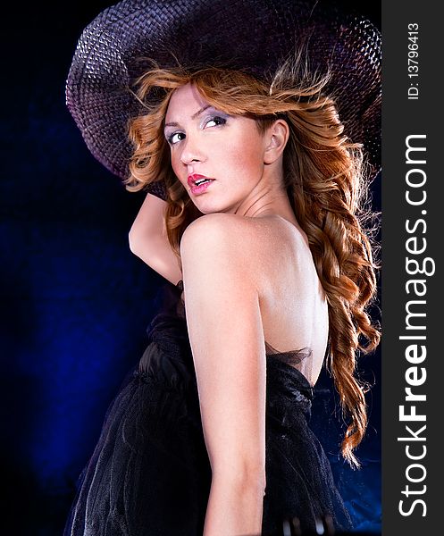 Photo-session of the young beautiful  woman with dark hat