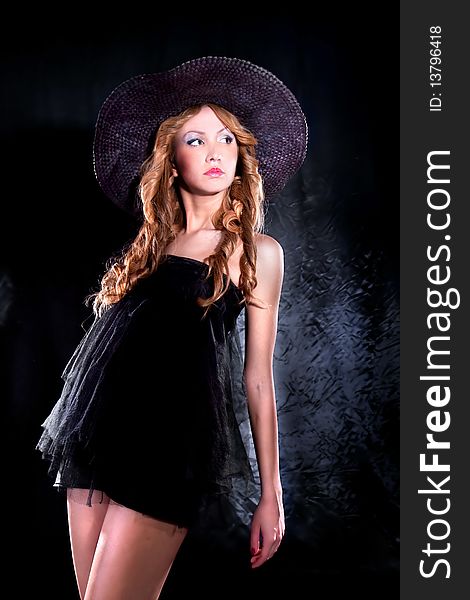 Photo-session of the young beautiful woman with dark hat. Photo-session of the young beautiful woman with dark hat