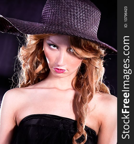 Photo-session of the young beautiful  woman with dark hat
