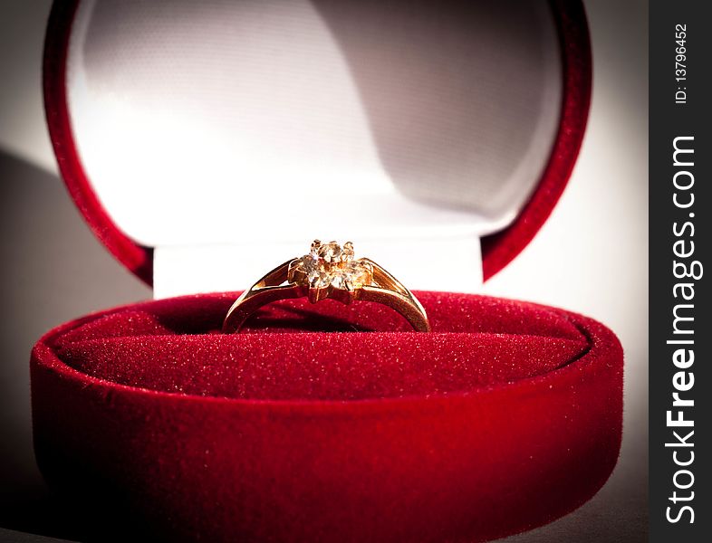 A golden ring in a red box. A golden ring in a red box