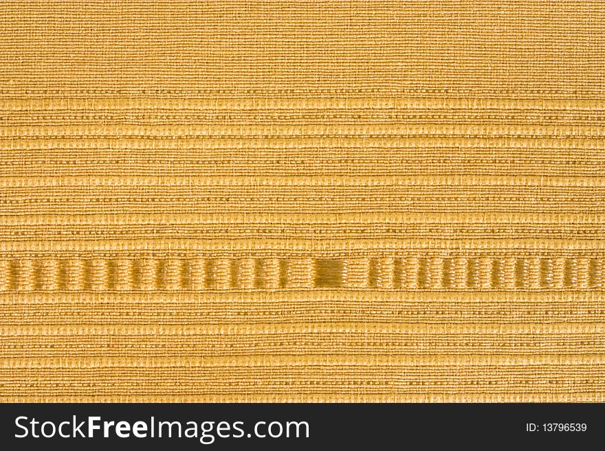 A close up of a yellow striped fabric background