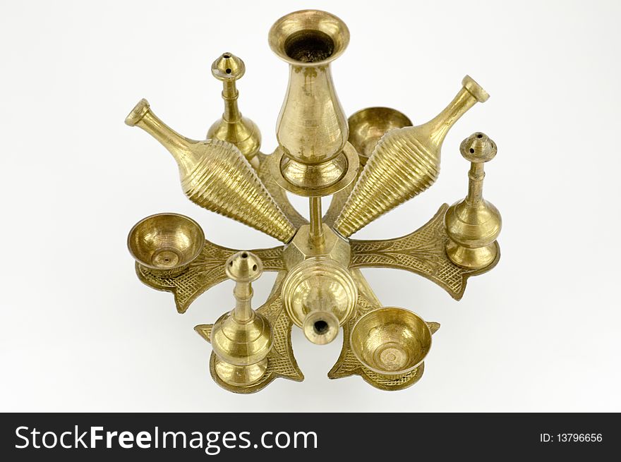 An old brass candlestick from XIX century. It is isolated on white background.