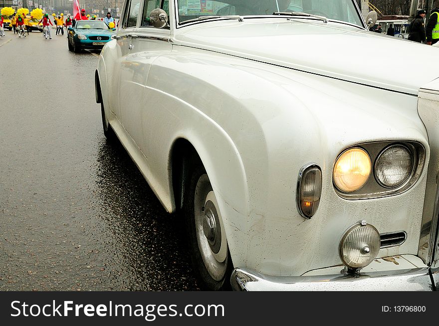 Old white car moving on the road. Old white car moving on the road