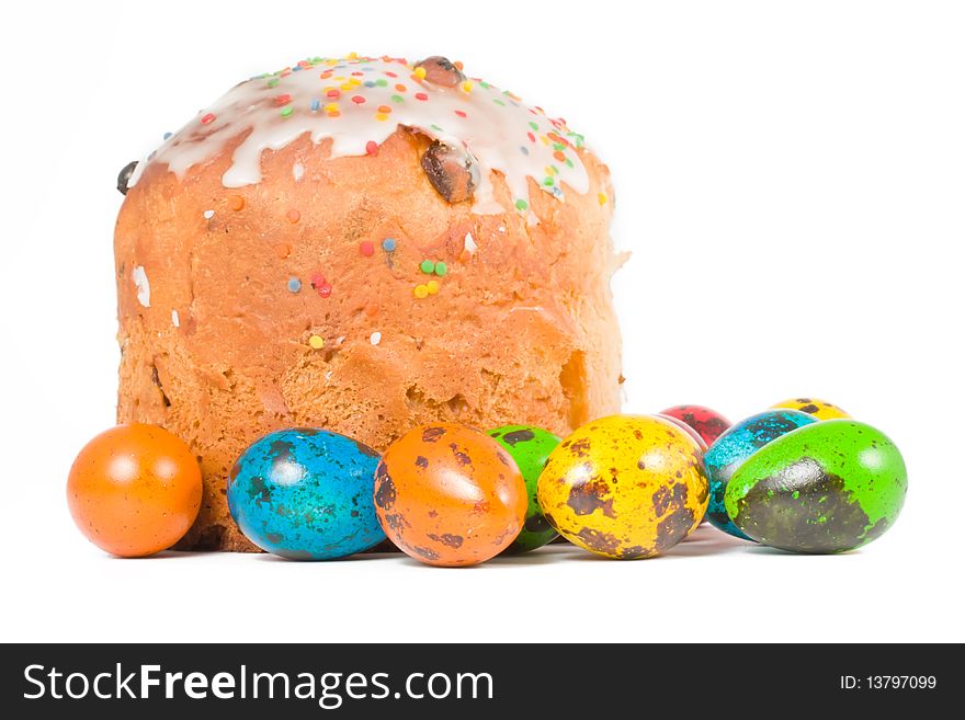 Easter cake and colored eggs on a white background