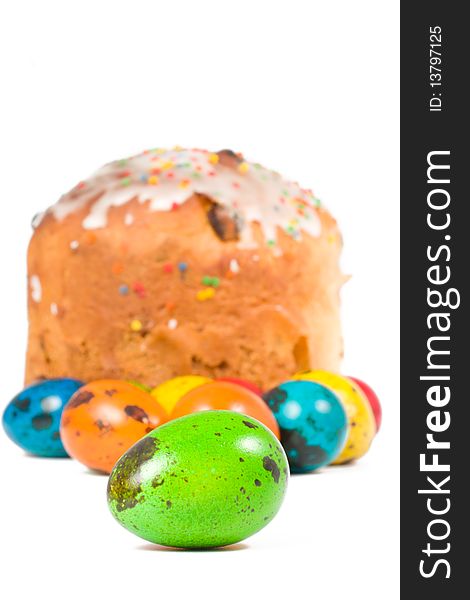 Easter cake and colored eggs on a white background