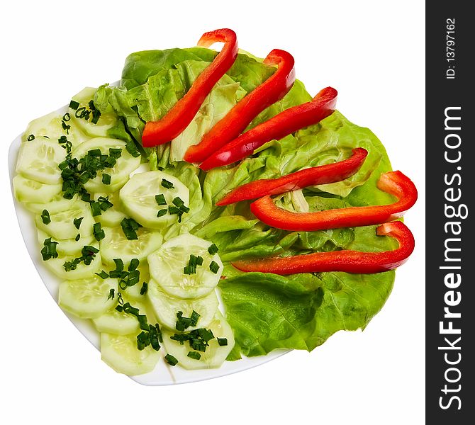 Cucumber slices with chive, lettuce and pepper on plate isolated over white background. Cucumber slices with chive, lettuce and pepper on plate isolated over white background.