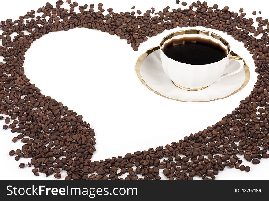 Flavored coffee in the cup and the heart of the coffee beans