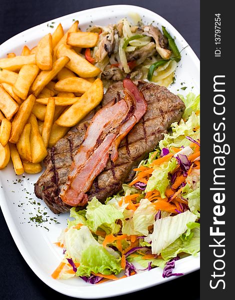 Sirloin steak with chips and bacon
